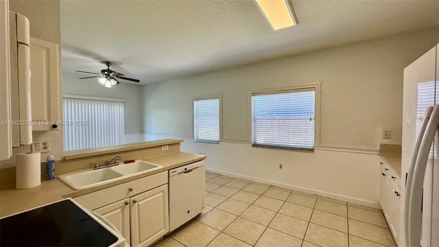 a view of a kitchen with cabinets and a stove top oven