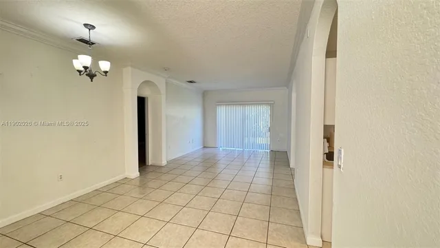 a view of a hallway with wooden floor and a bathroom