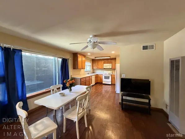 a living room with furniture a flat screen tv and a table