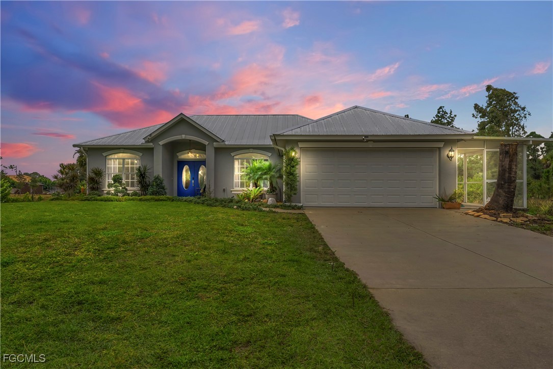 a front view of a house with a garden and yard