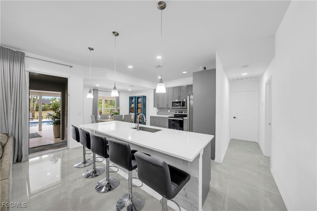 7881 Buckingham Road Fort Myers, FL 33905 - Photo 11 of 49 a large kitchen with a table and chairs