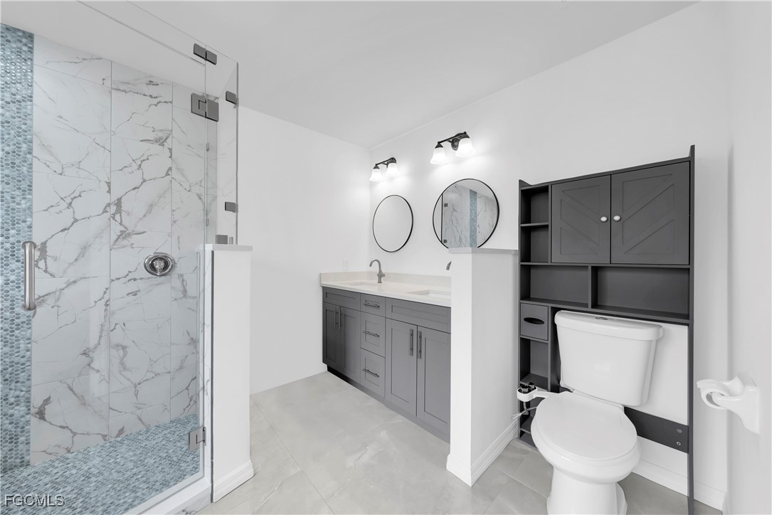 7881 Buckingham Road Fort Myers, FL 33905 - Photo 22 of 49 a bathroom with a toilet sink and mirror