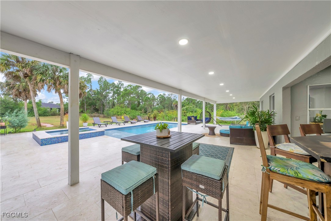 7881 Buckingham Road Fort Myers, FL 33905 - Photo 30 of 49 a view of a dining room with furniture large windows and garden view