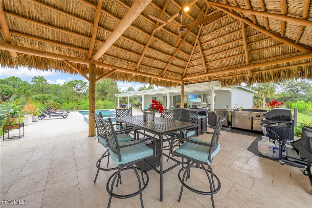7881 Buckingham Road Fort Myers, FL 33905 - Photo 32 of 49 a view of a patio with table and chairs