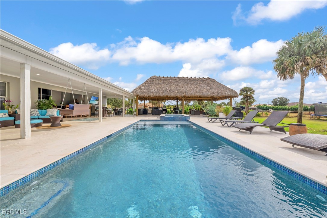 7881 Buckingham Road Fort Myers, FL 33905 - Photo 36 of 49 a swimming pool with outdoor seating and yard