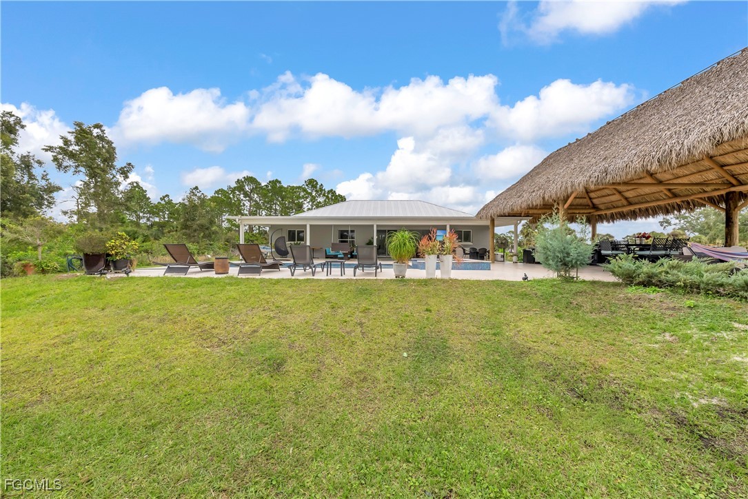 7881 Buckingham Road Fort Myers, FL 33905 - Photo 39 of 49 a view of swimming pool with outdoor seating and trees in the background