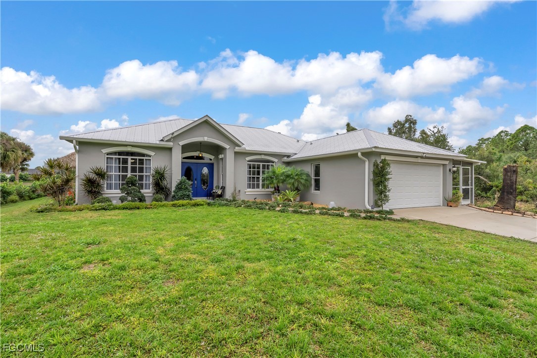 7881 Buckingham Road Fort Myers, FL 33905 - Photo 42 of 49 front view of a house with a yard
