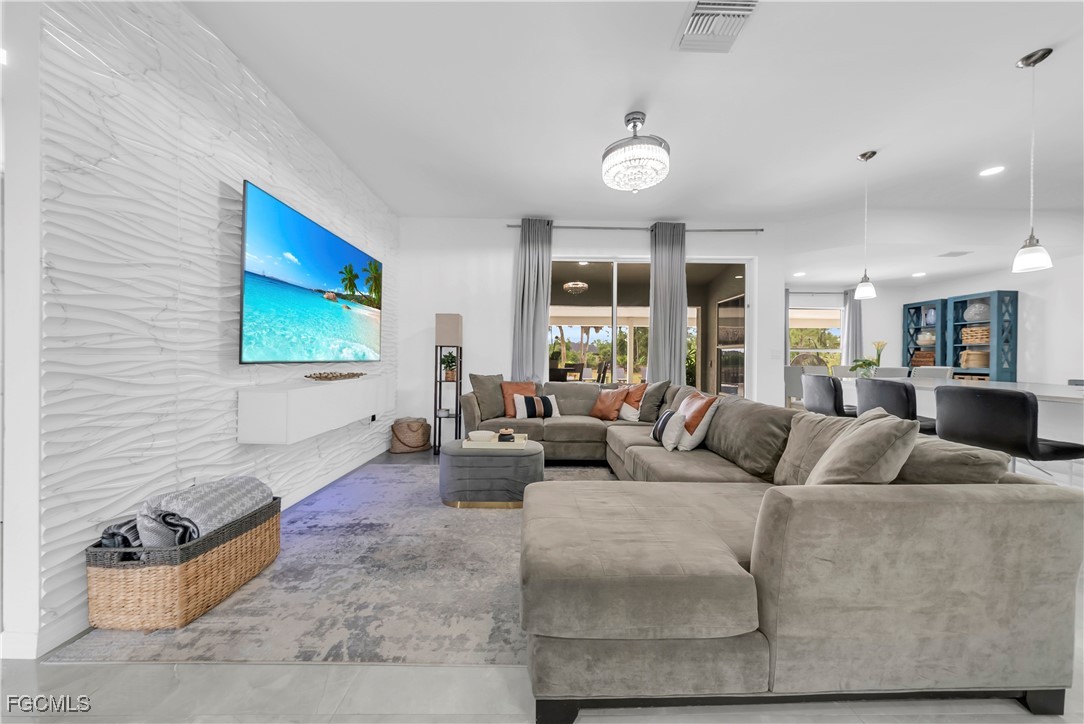 7881 Buckingham Road Fort Myers, FL 33905 - Photo 6 of 49 a living room with furniture and a flat screen tv