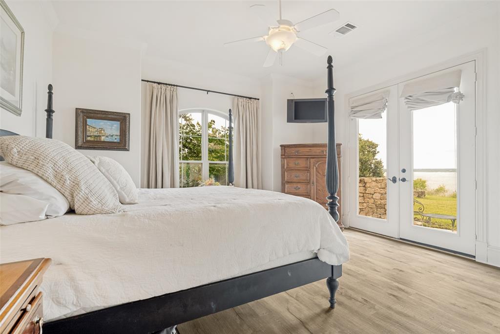 1237 Overlook Court Whitney, TX 76692 - Photo 11 of 20 a bedroom with a large bed and a large window