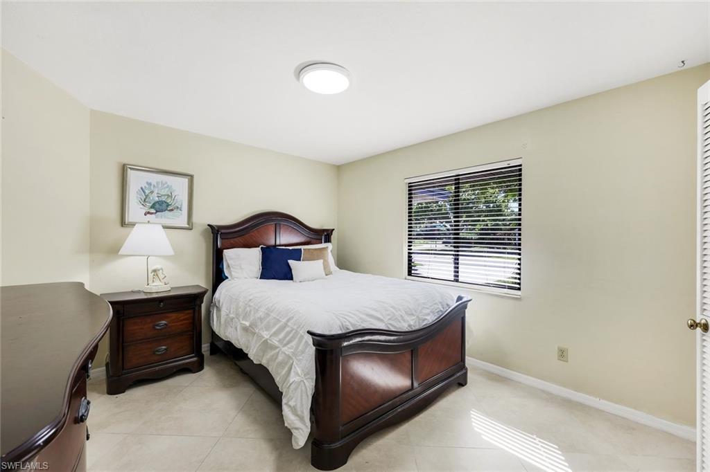 2383 Mayfield Court, Unit 4 Naples, FL 34105 - Photo 12 of 21 a bedroom with a bed and a window