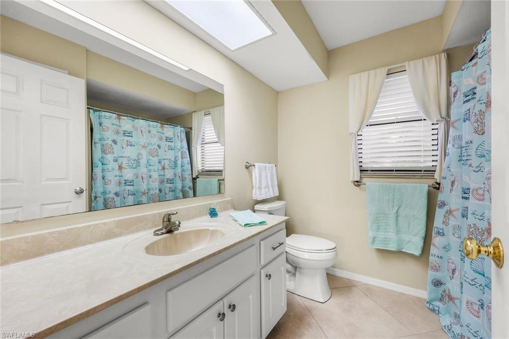 2383 Mayfield Court, Unit 4 Naples, FL 34105 - Photo 13 of 21 a bathroom with a sink a toilet and shower