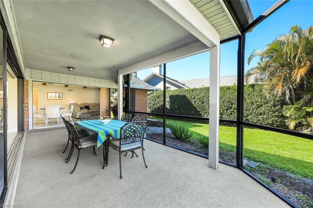 2383 Mayfield Court, Unit 4 Naples, FL 34105 - Photo 15 of 21 a dining room with furniture and garden view