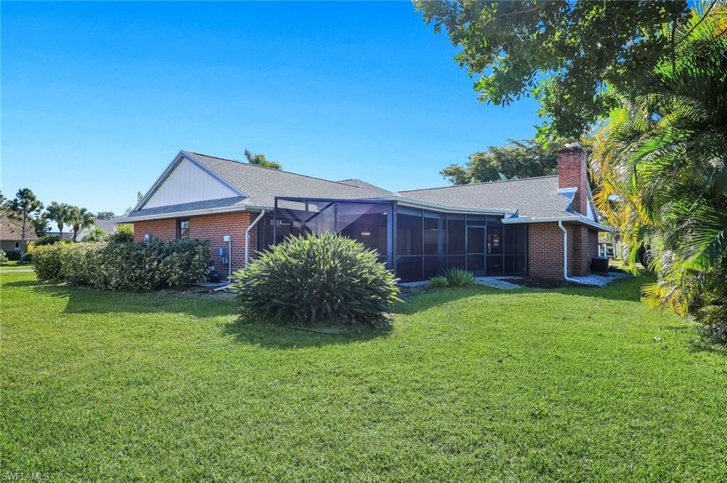 2383 Mayfield Court, Unit 4 Naples, FL 34105 - Photo 19 of 21 a front view of a house with garden