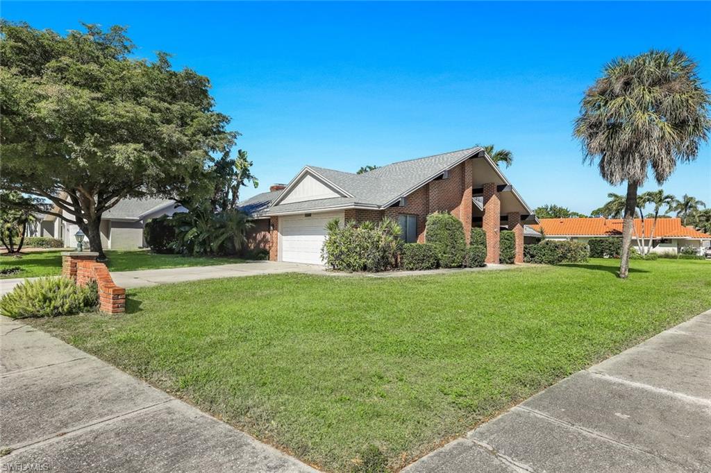 2383 Mayfield Court, Unit 4 Naples, FL 34105 - Photo 21 of 21 a front view of house with yard and green space