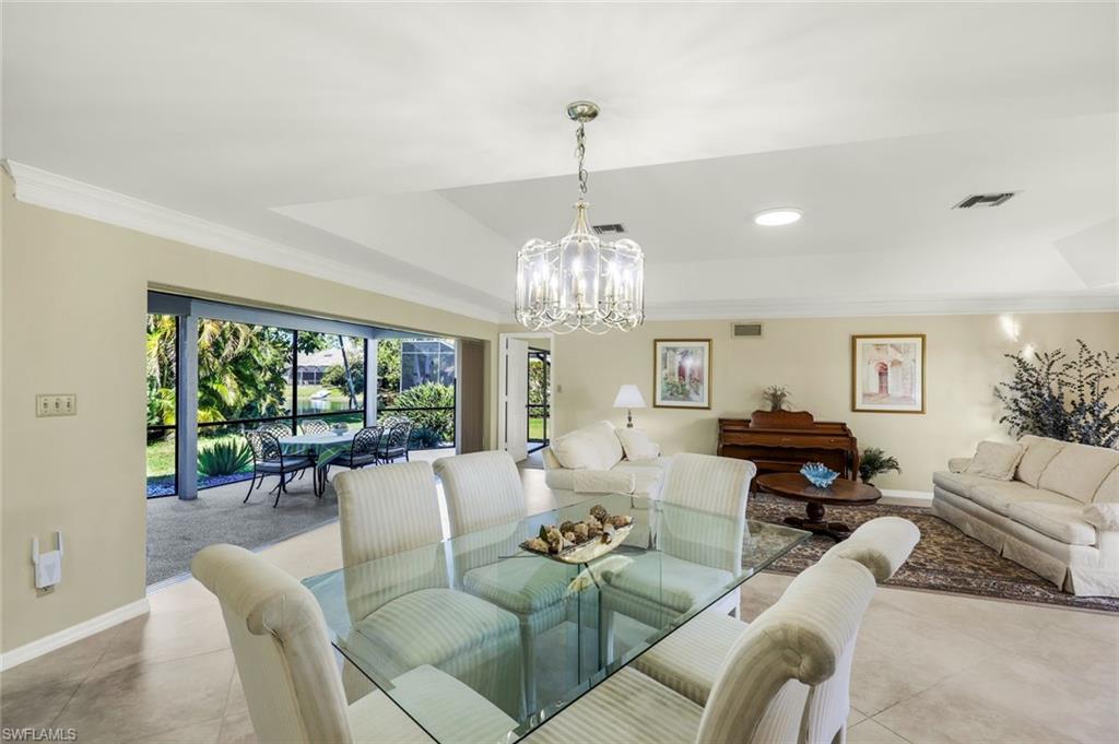 2383 Mayfield Court, Unit 4 Naples, FL 34105 - Photo 4 of 21 a living room with furniture and a chandelier