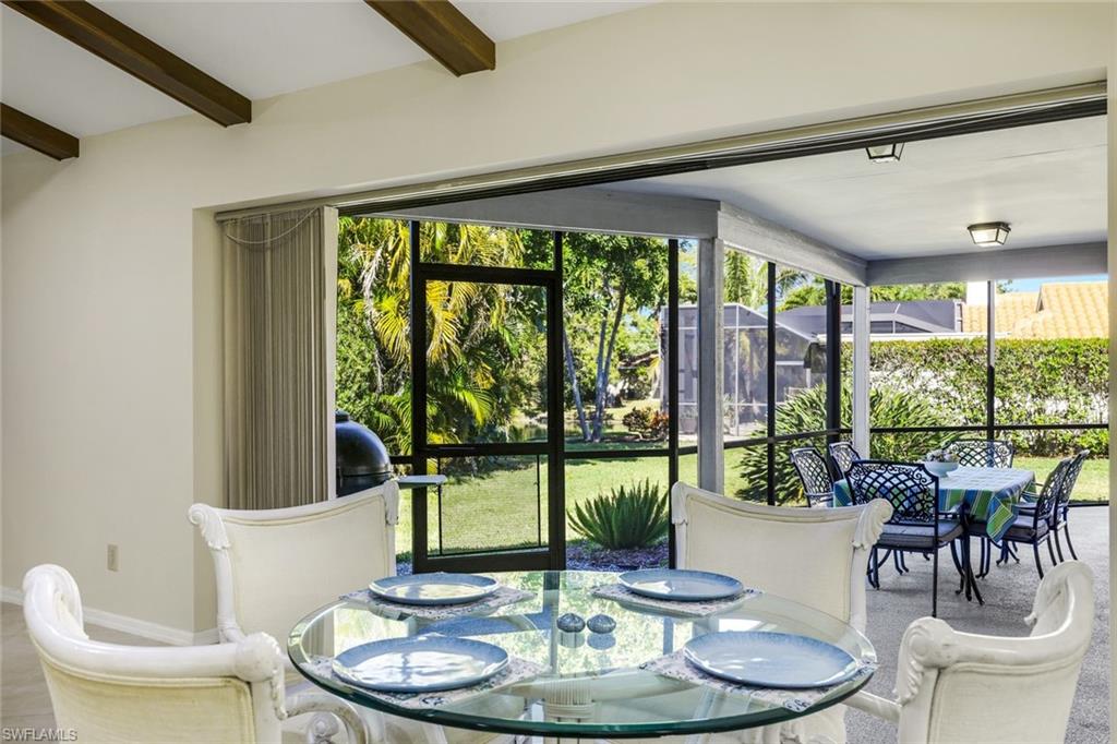 2383 Mayfield Court, Unit 4 Naples, FL 34105 - Photo 7 of 21 a view of a dining room with furniture window and outside view