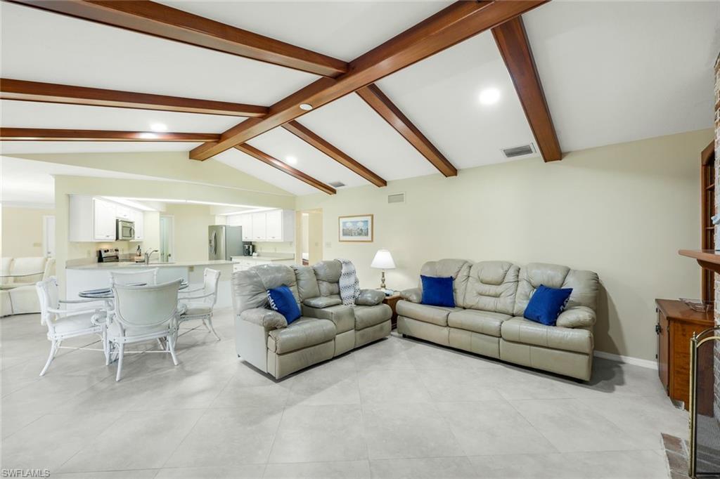 2383 Mayfield Court, Unit 4 Naples, FL 34105 - Photo 8 of 21 a living room with furniture and a large window