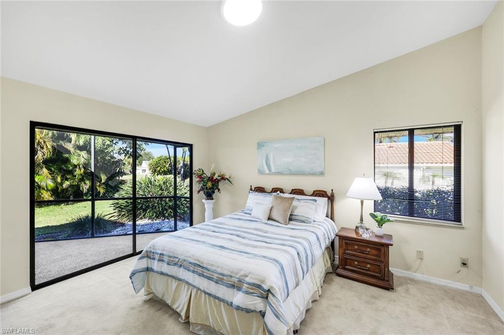 2383 Mayfield Court, Unit 4 Naples, FL 34105 - Photo 10 of 21 a bedroom with a large bed and a large window