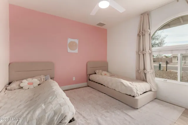 a bedroom with a bed and a large window with outer view