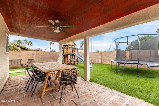 a view of a backyard with a table and chairs