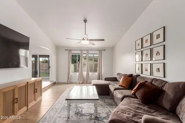 a living room with furniture and a chandelier