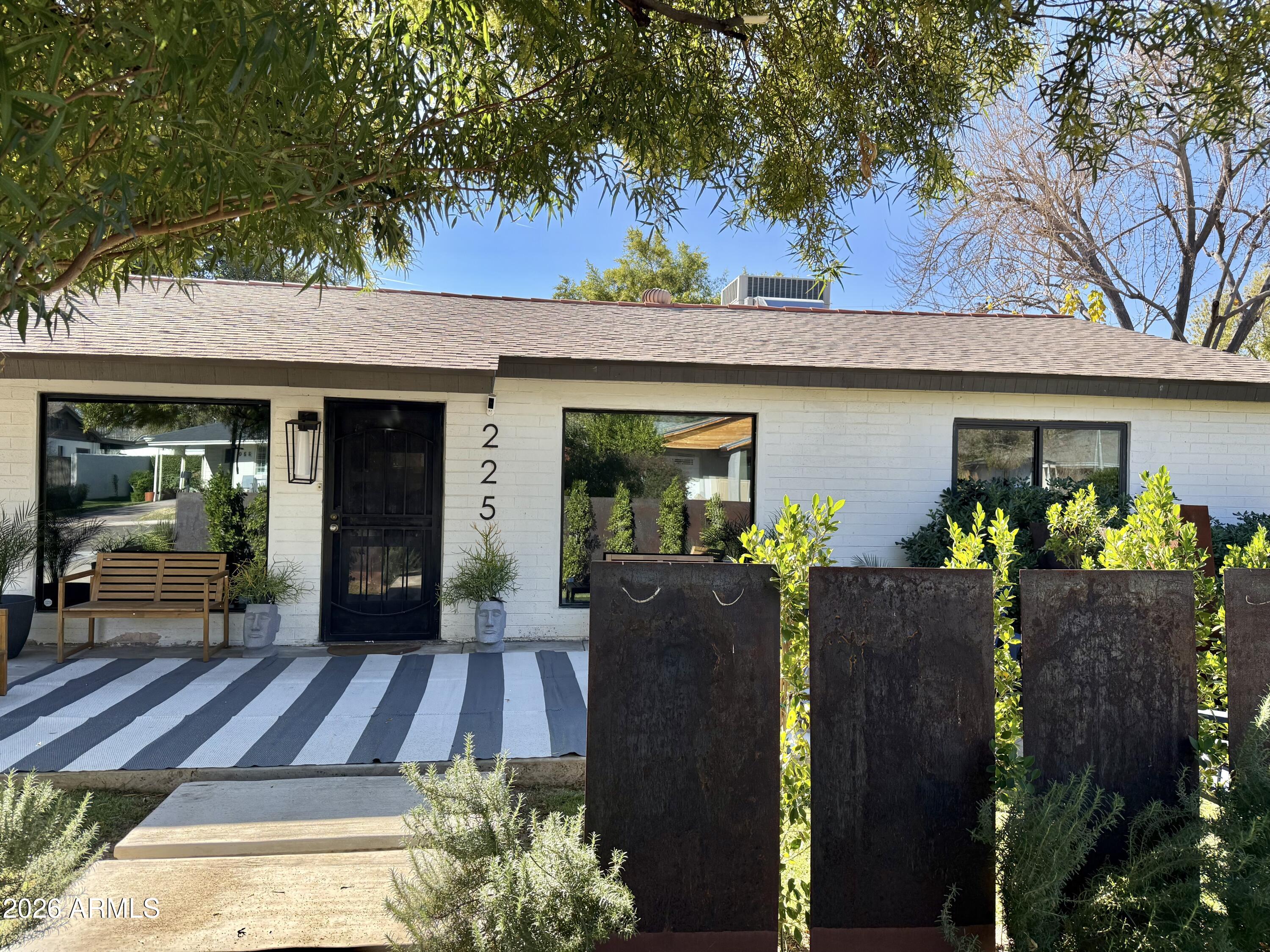 a view of a house with wooden floor and potted plants