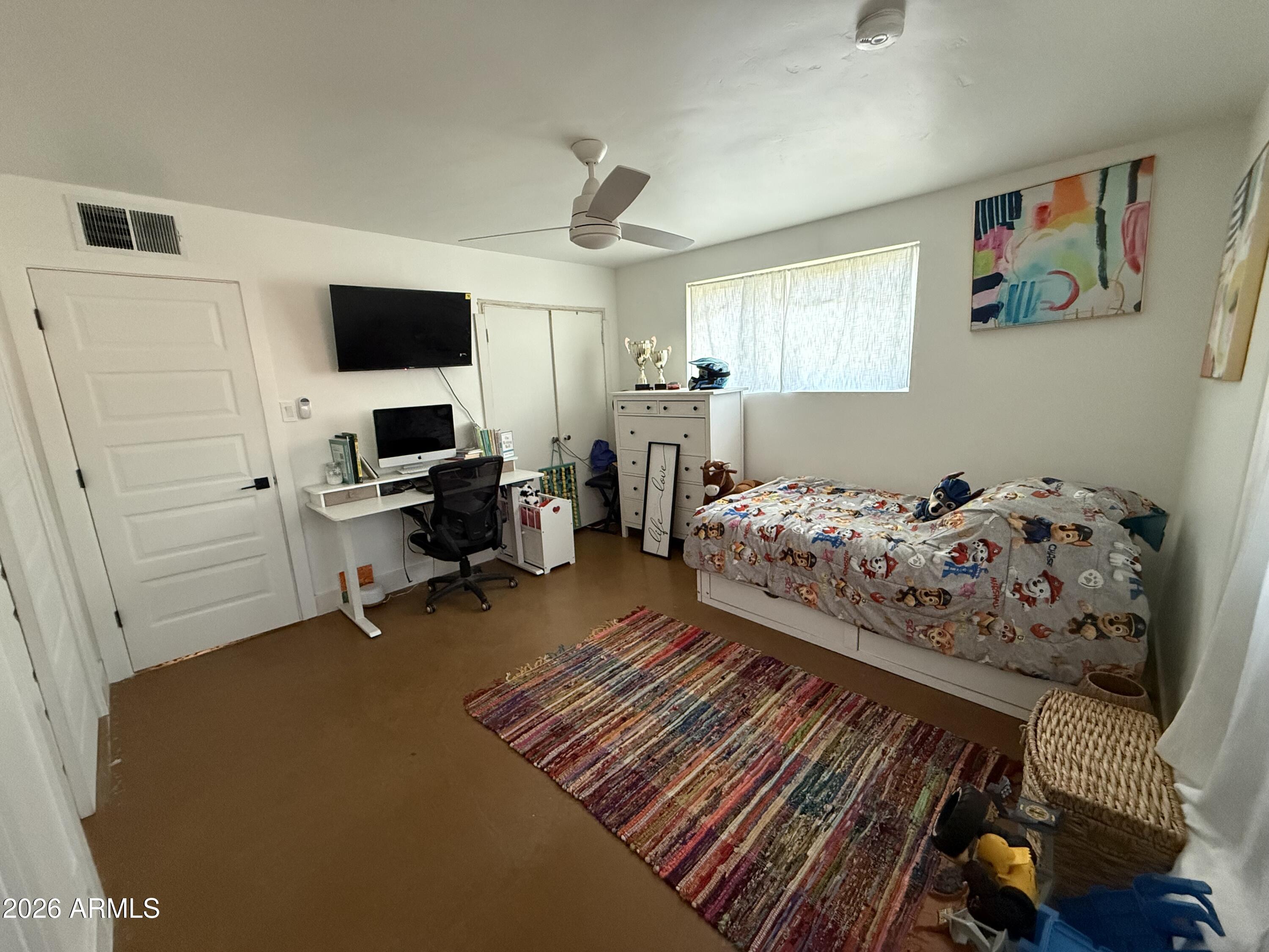 225 West Alice Avenue Phoenix, AZ 85021 - Photo 22 of 29 a bedroom with furniture and a flat screen tv
