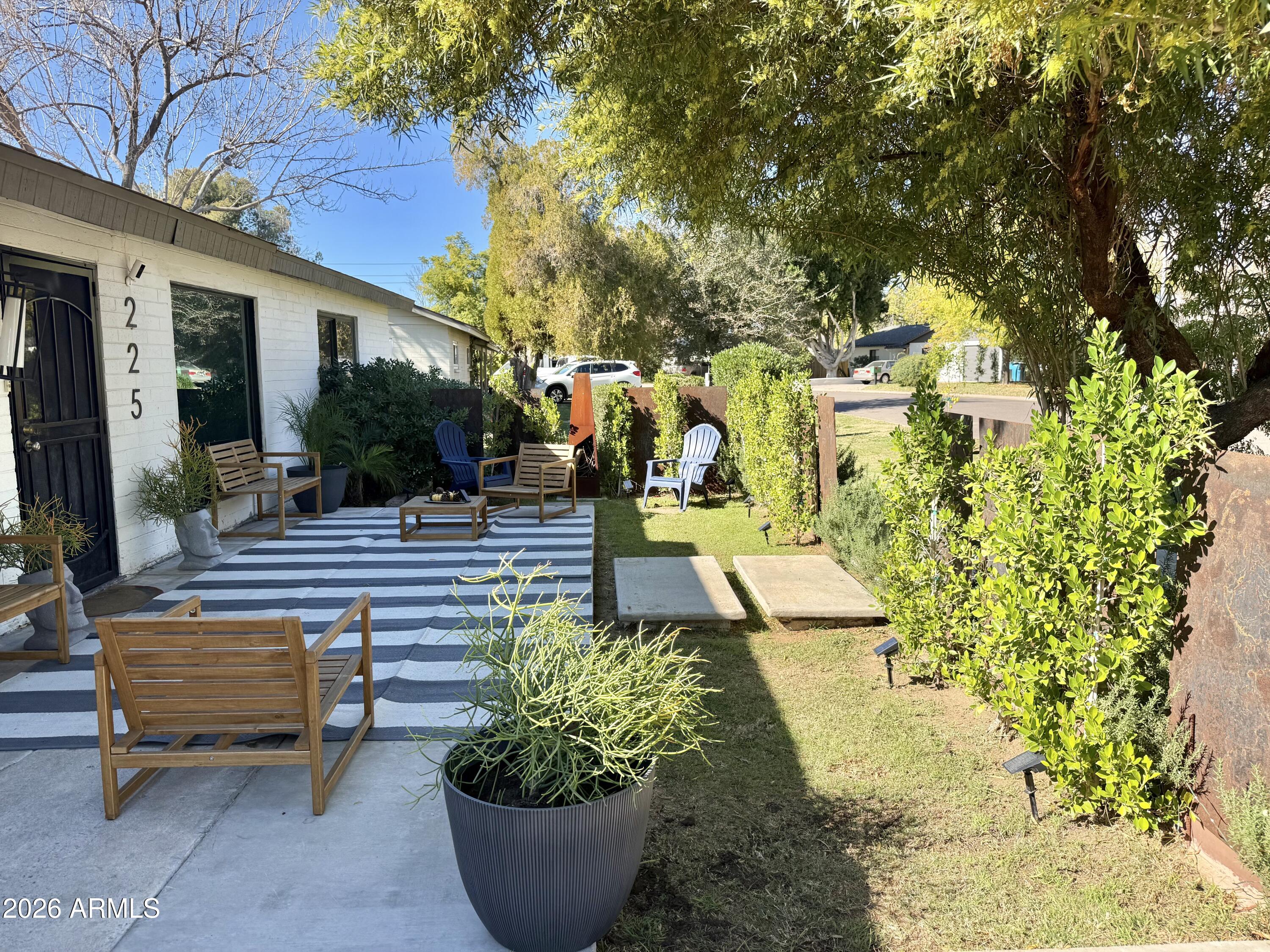 225 West Alice Avenue Phoenix, AZ 85021 - Photo 3 of 29 a view of a patio with couches and table and chairs and potted plants