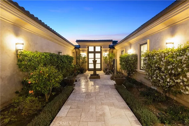 a lobby with furniture and floor to ceiling window and potted plants