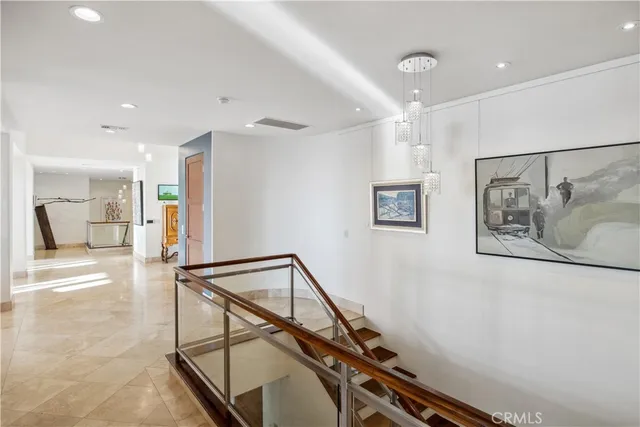 a view of a hallway with wooden floor and stairs