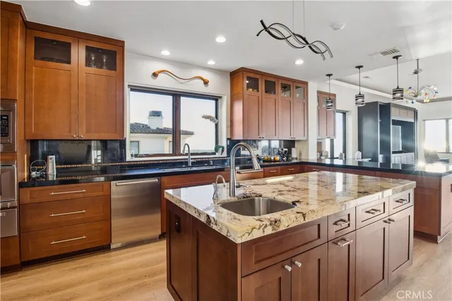 a kitchen with a stove a sink and a refrigerator