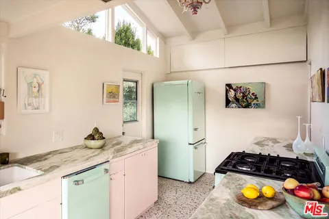 a kitchen with granite countertop a stove and cabinets