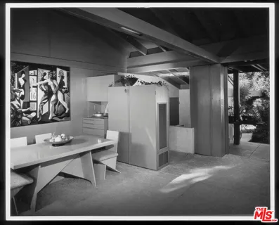 a bedroom with three beds and a large window