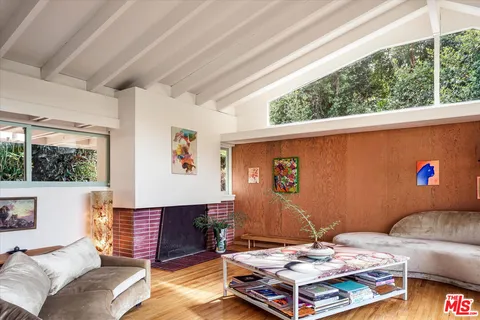 a living room with furniture and a floor to ceiling window
