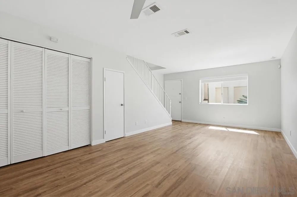 5130 North River Road, Unit B Oceanside, CA 92057 - Photo 24 of 51 a view of an empty room with wooden floor and a window