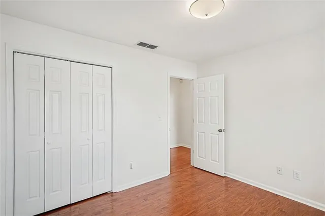 a view of a room with wooden floor
