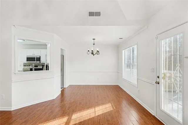 a kitchen with a refrigerator and a stove top oven