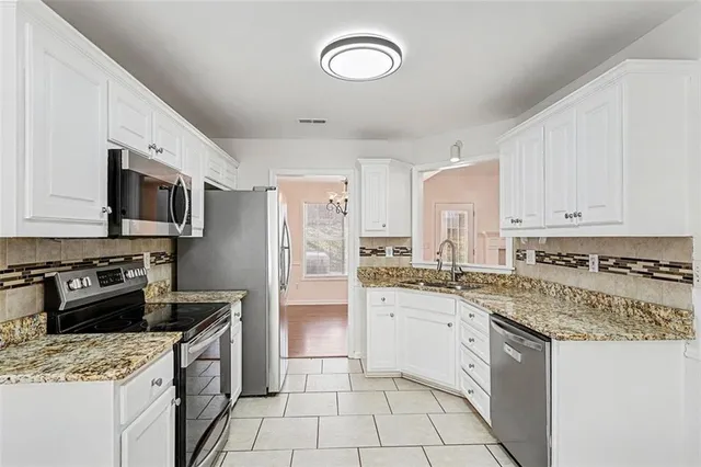 a kitchen with a sink stove top oven and refrigerator