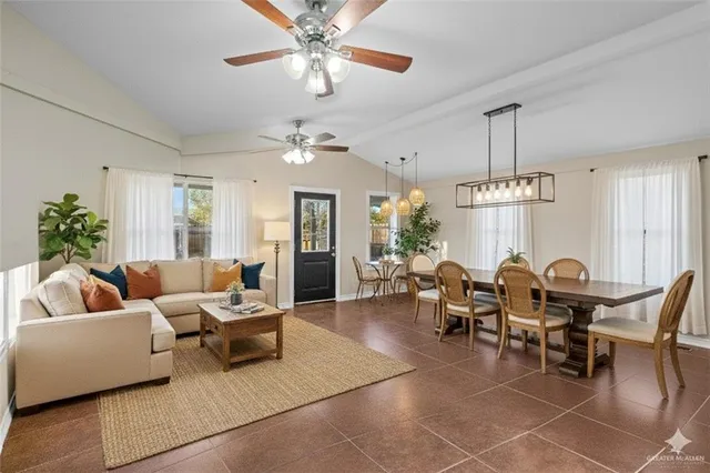 a living room with patio furniture and a chandelier