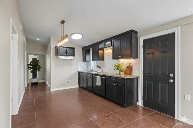 a kitchen with stainless steel appliances a sink stove and cabinets