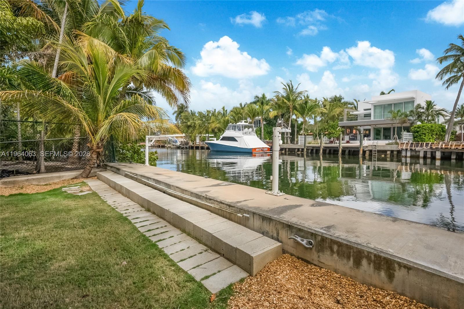 278 South Island Road Golden Beach, FL 33160 - Photo 12 of 57 a view of a lake with a yard and large trees