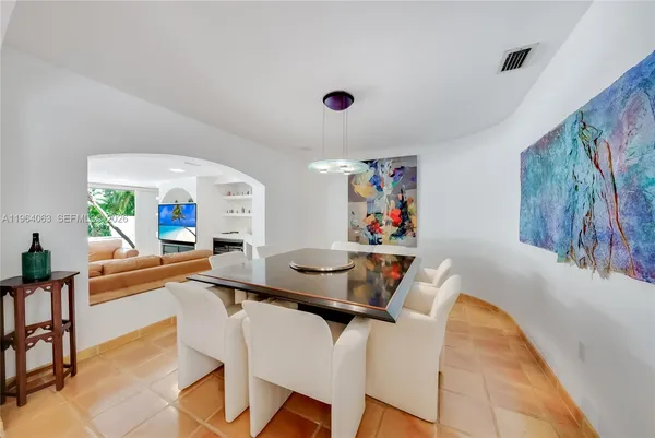 a dining room with furniture and a window