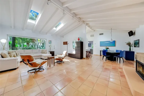a living room with furniture and a dining table