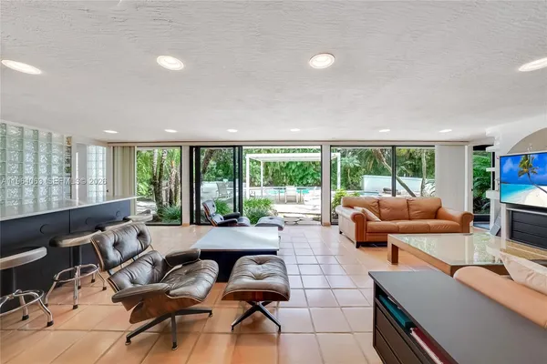 a living room with furniture and large windows