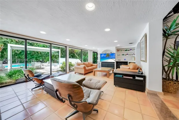 a living room with furniture and a floor to ceiling window