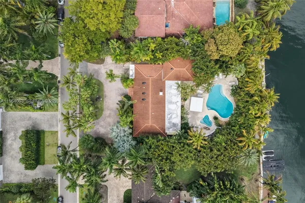 an aerial view of a house with a yard and garden