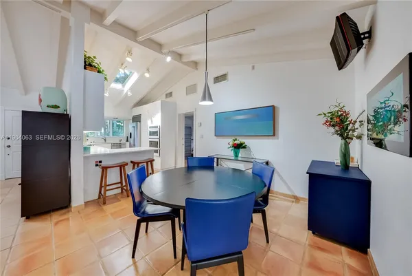 a dining room with furniture and window