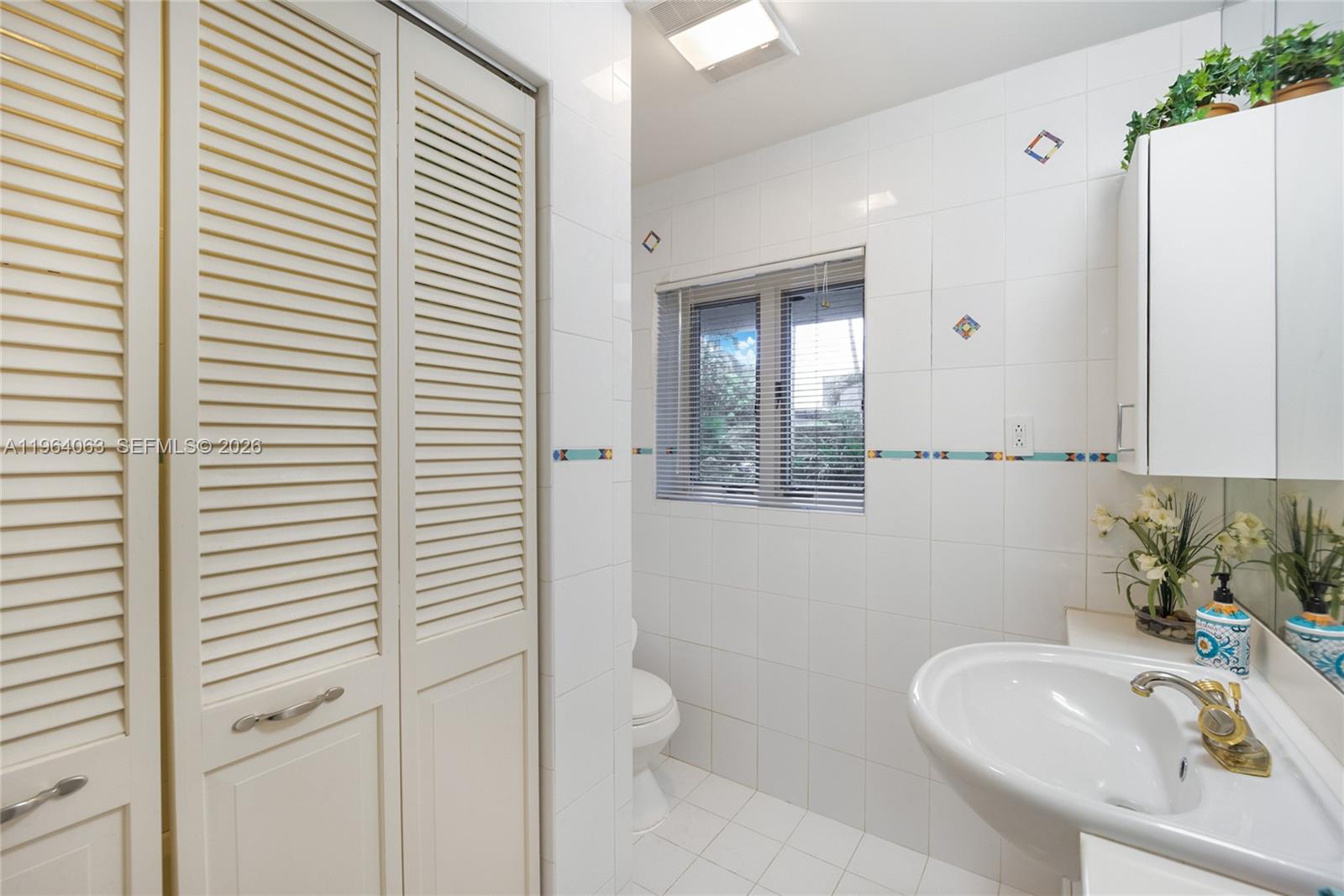 278 South Island Road Golden Beach, FL 33160 - Photo 31 of 57 a bathroom with a sink and a mirror