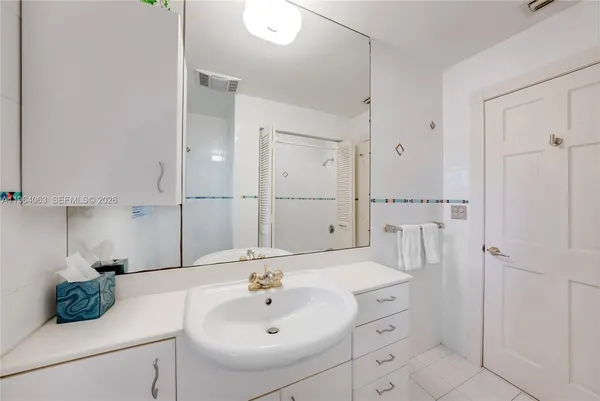 a living room with furniture a floor to ceiling window and floor to ceiling window