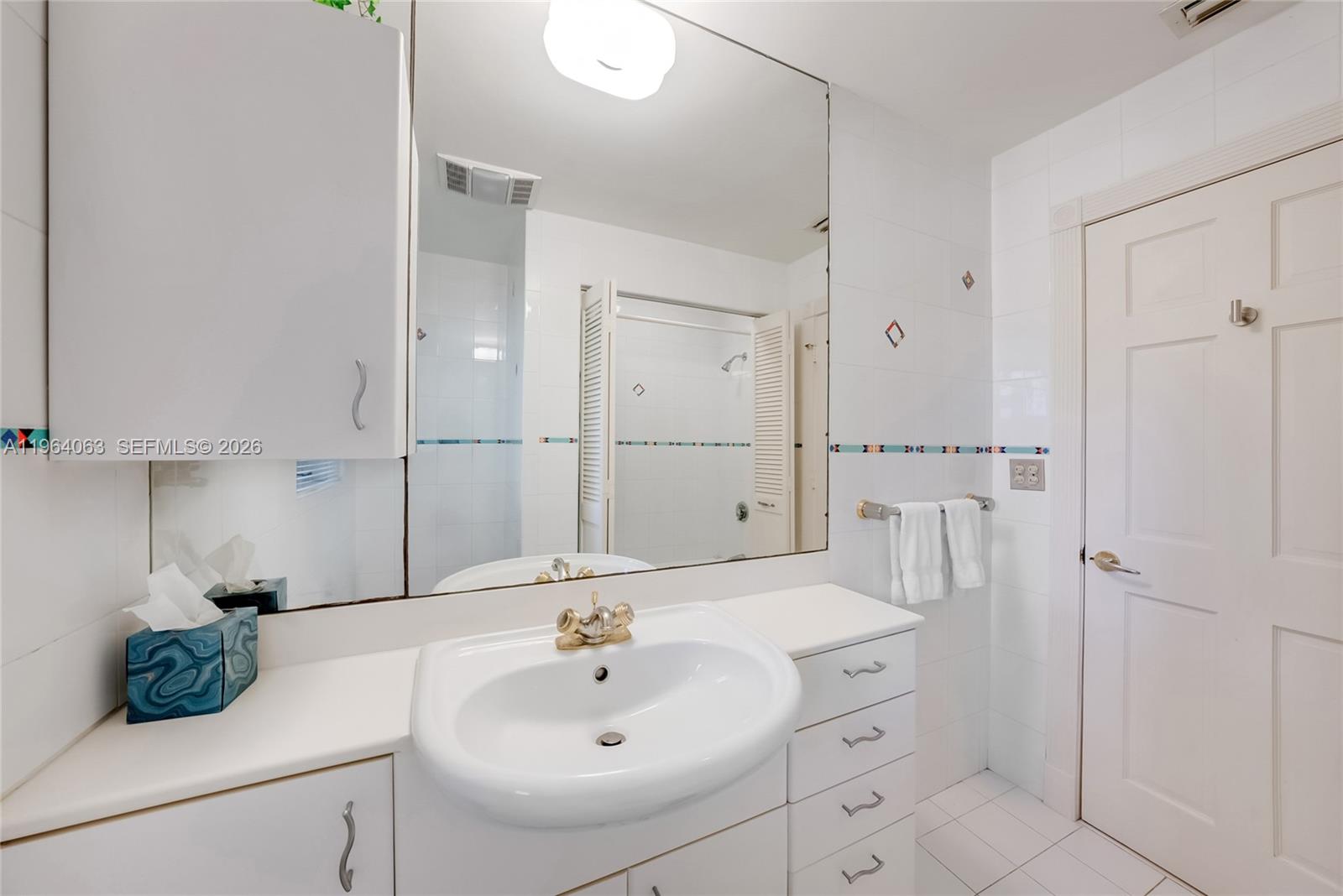 278 South Island Road Golden Beach, FL 33160 - Photo 32 of 57 a bathroom with a sink and a mirror